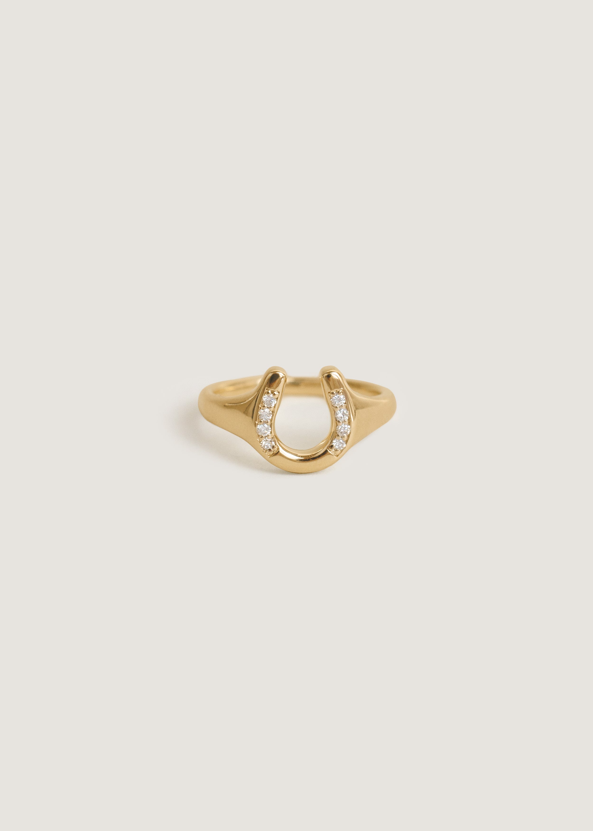 Kinn Studio 14k Gold Horseshoe Diamond Signet Ring on a white background