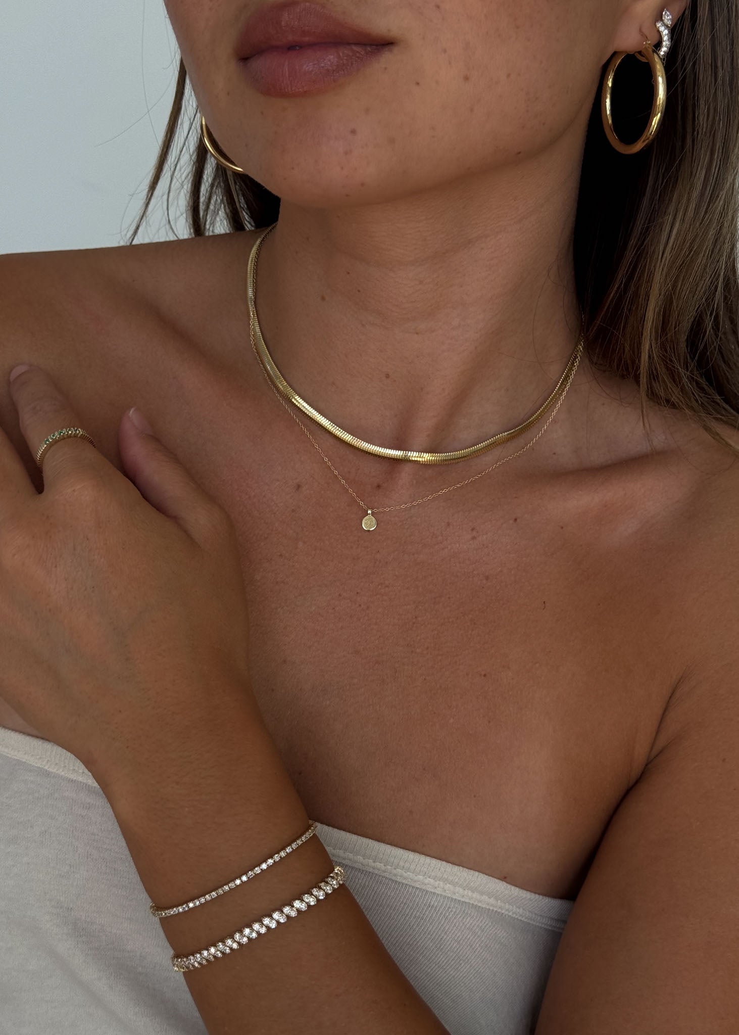 woman wearing a Kinn 14k Gold Classic Diana Tennis Bracelet 2.90ctw stacked with a Sofia Marquise Diamond Tennis Bracelet