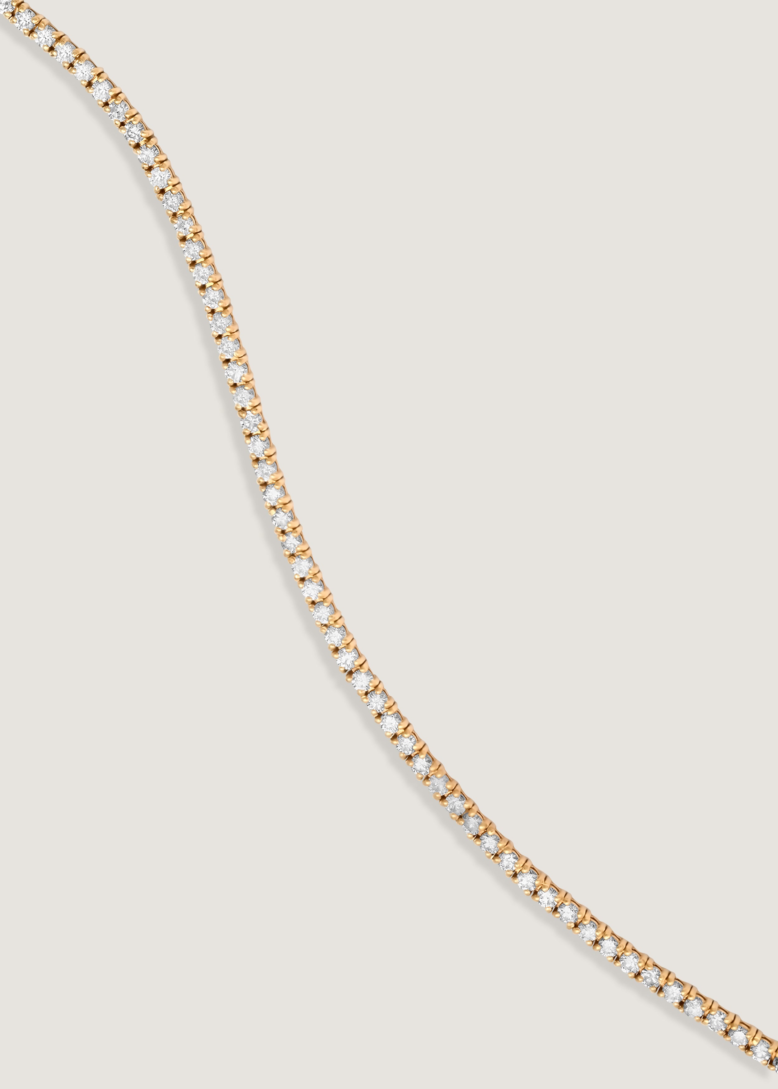 a Kinn 14k Gold Classic Diana Tennis Bracelet 2.90ctw laying flat across
