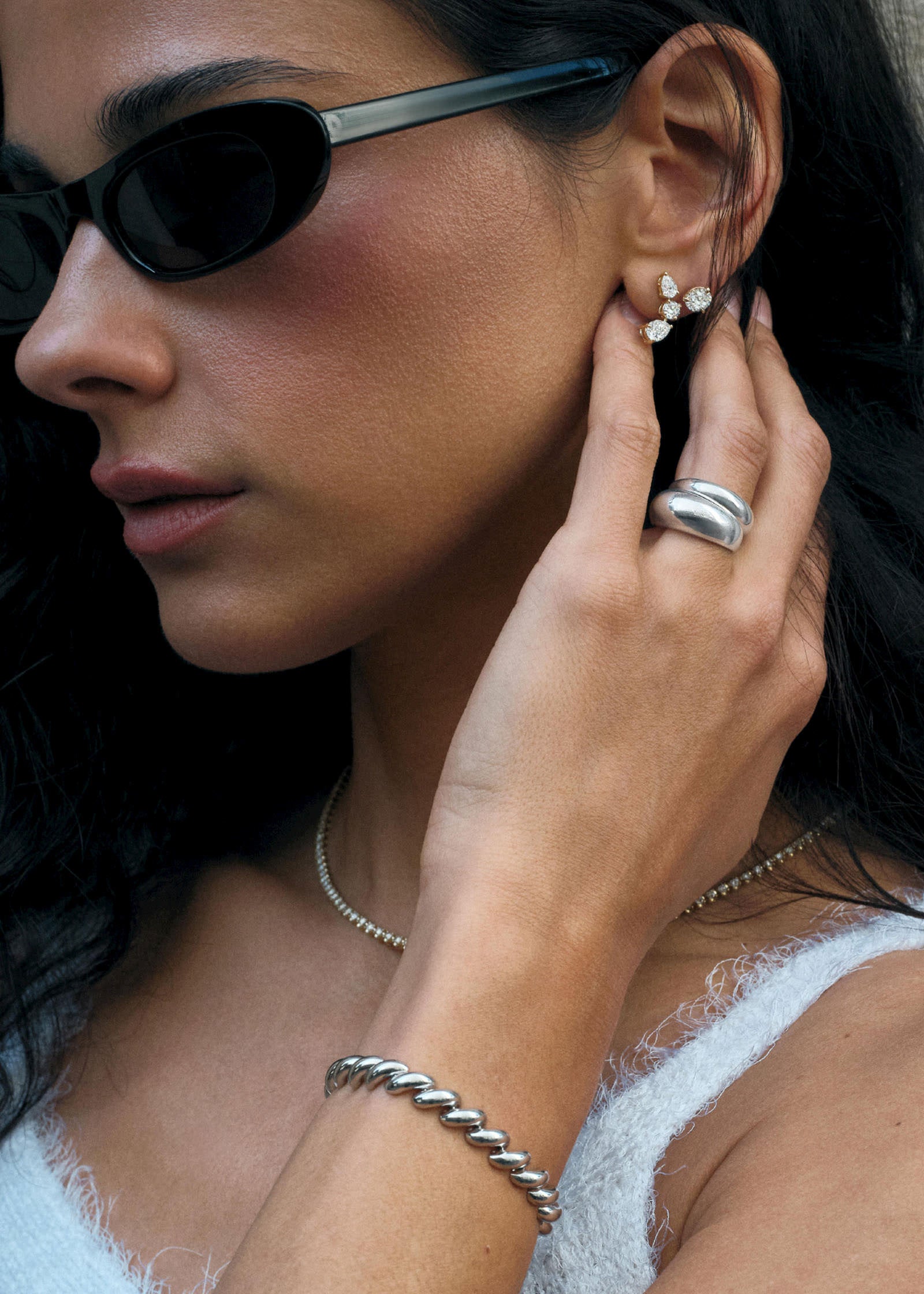 woman in sunglasses wearing a Kinn Studio Sterling Silver Dare To Love Bold Hollow Dome Ring layered with a Dare to Love Dome Ring and a Hampshire house bracelet