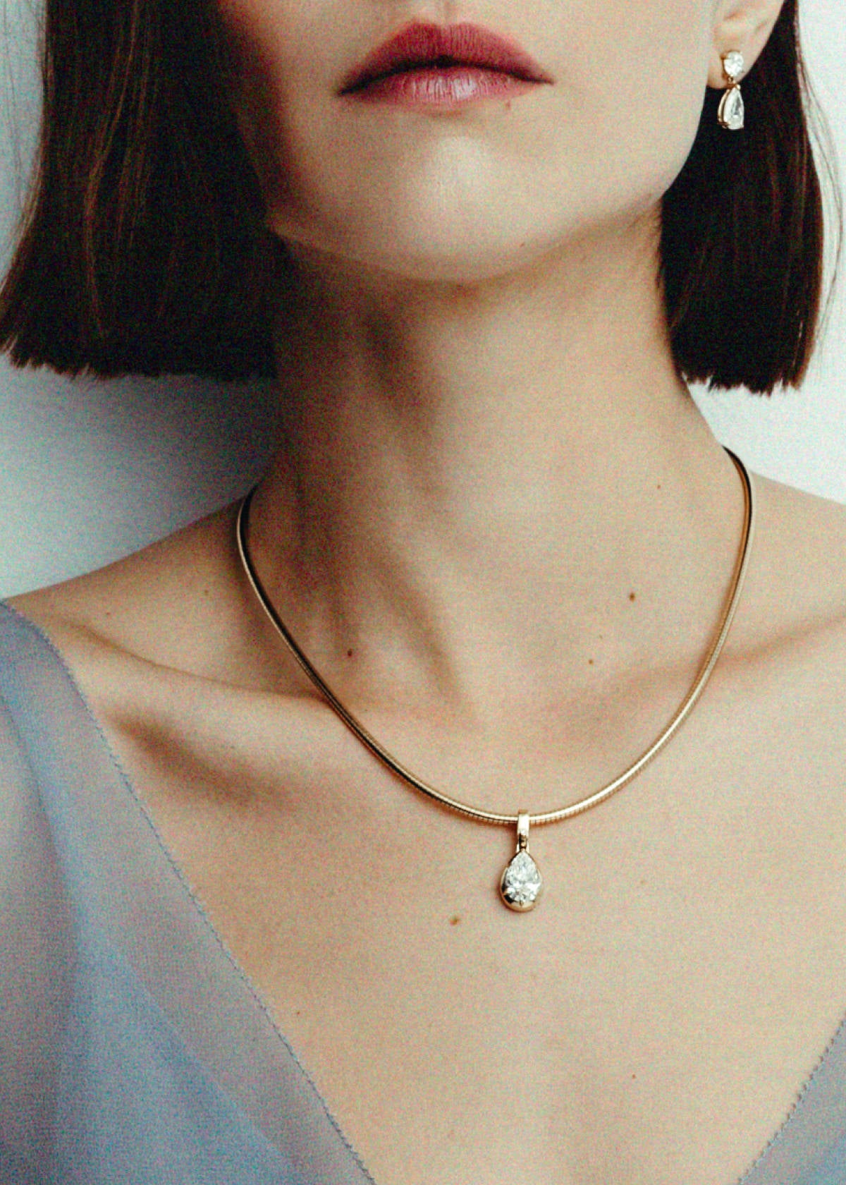 woman wearing a Kinn Studio 14k Gold Madeleine Pear Diamond Pendant Necklace