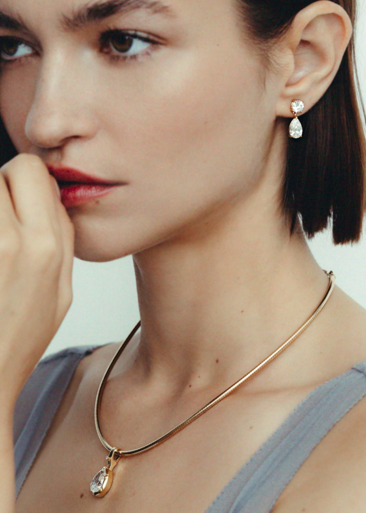woman wearing a Kinn Studio 14k Gold Madeleine Pear Diamond Pendant Necklace on Heirloom Curved Chain