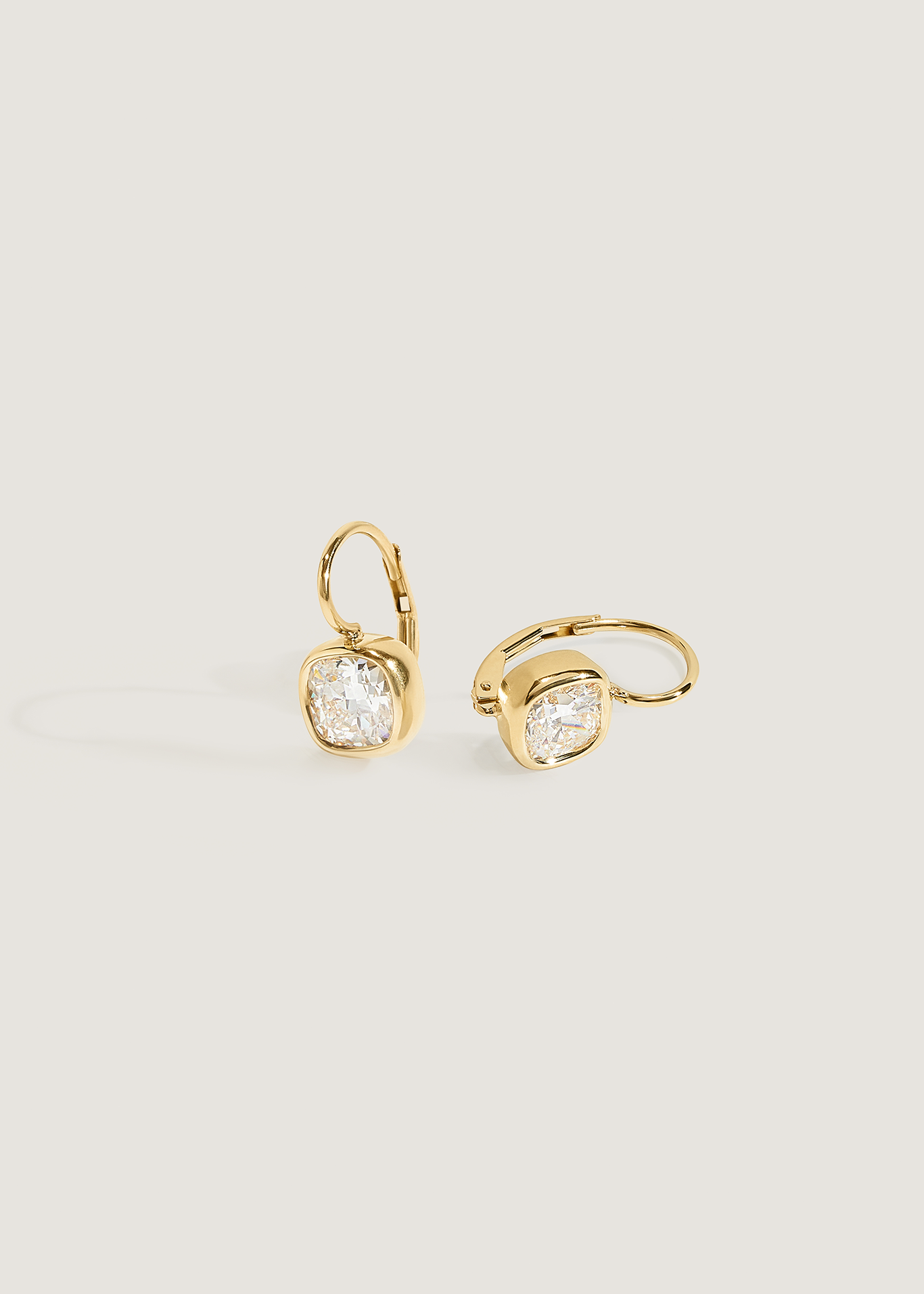 Kinn 14k Gold Harper 2ctw Cushion Cut Diamond Drop Earrings with one laying on its side