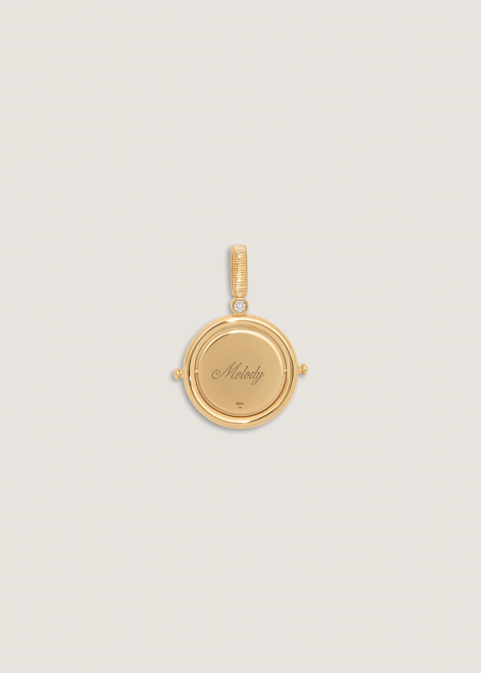 A Kinn 14k Gold Round North Star Birthstone Diamond Pendant engraved with Melody on one side