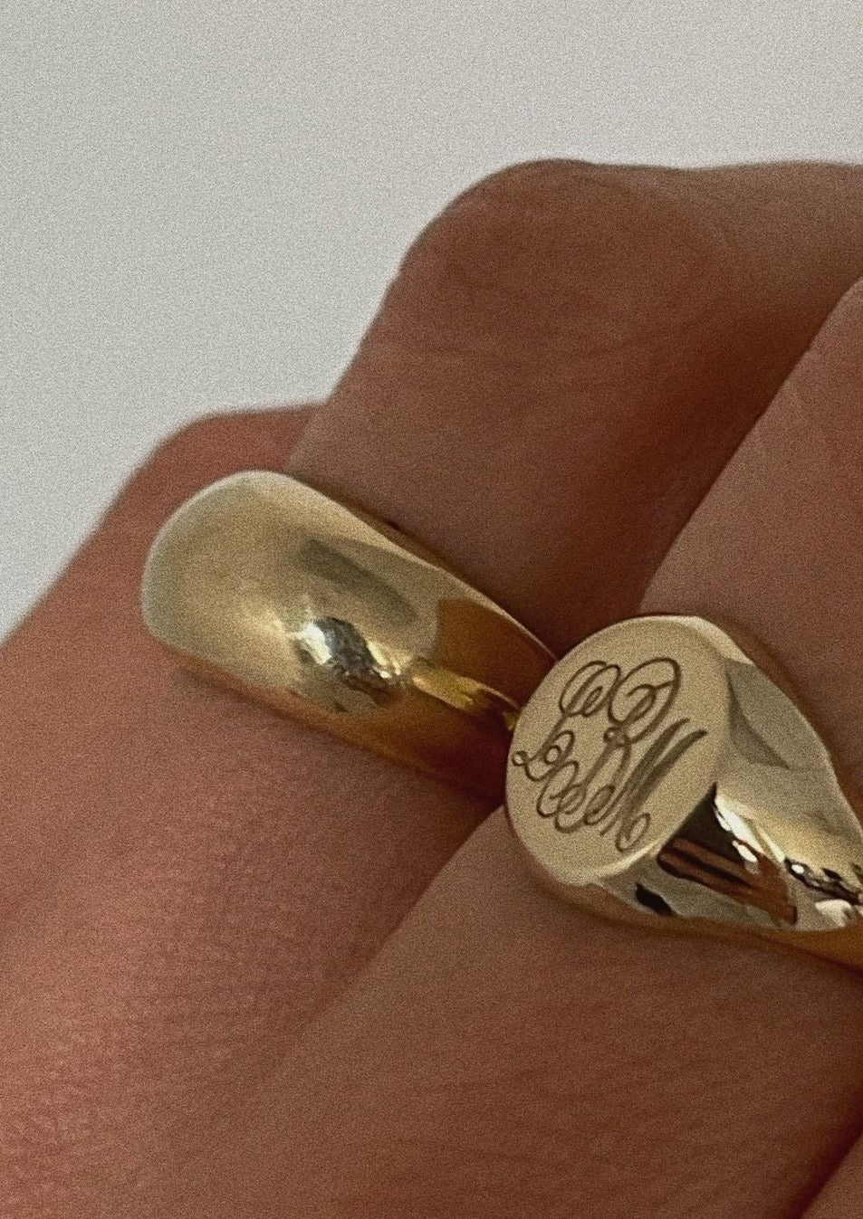 close up of a woman wearing a Kinn 14k gold Bold Classic Signet Ring engraved with a monogram