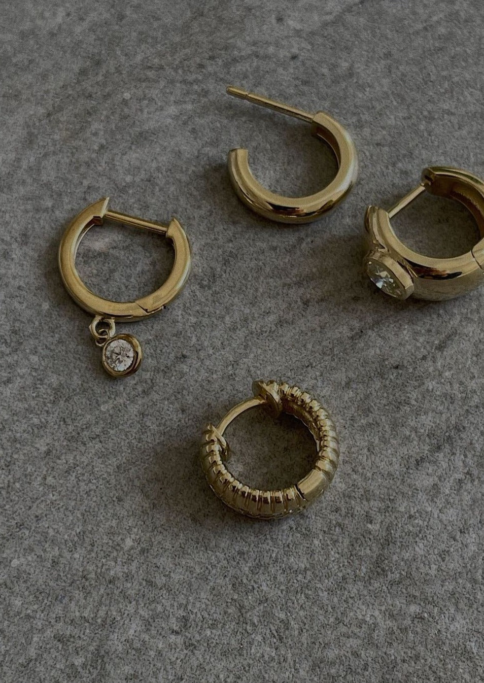 alt="Solis Ribbed Pavé Earrings with kara round huggies and ynez dome huggies"