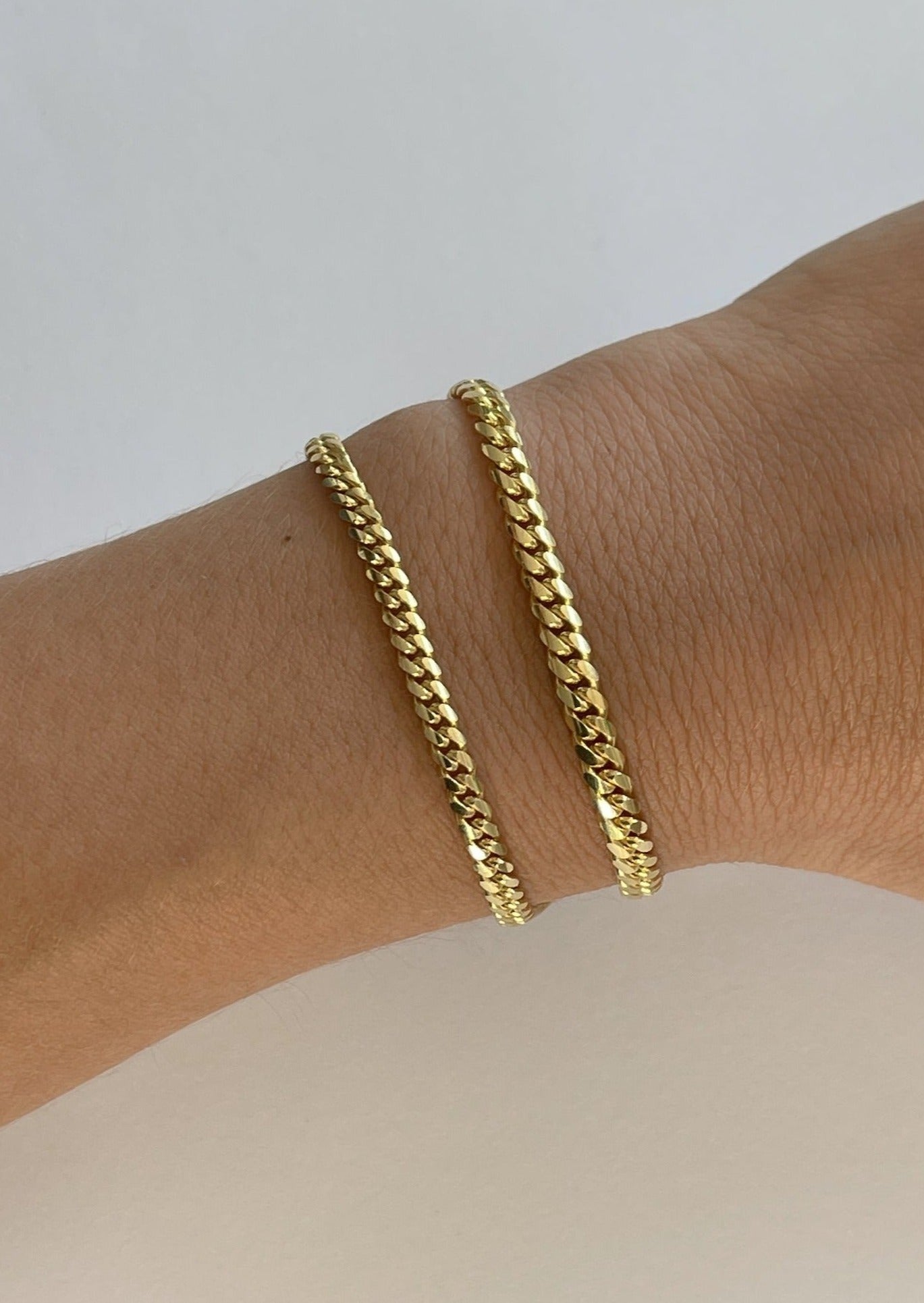 alt="Micro Familia Cuban Bracelet and petite familia cuban bracelet"